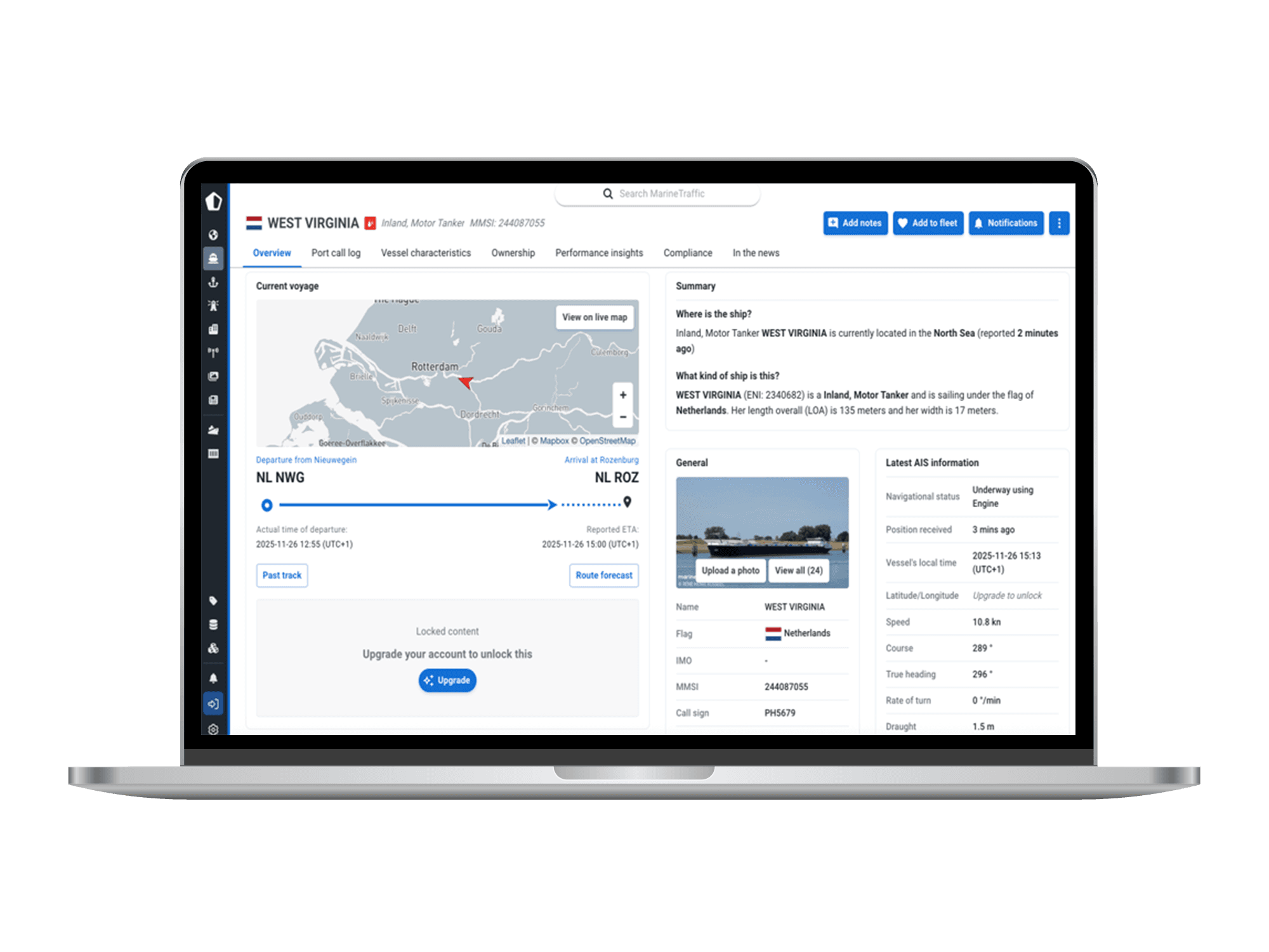MarineTraffic vessel information for WEST VIRGINIA, showing a voyage map and AIS details on a laptop.